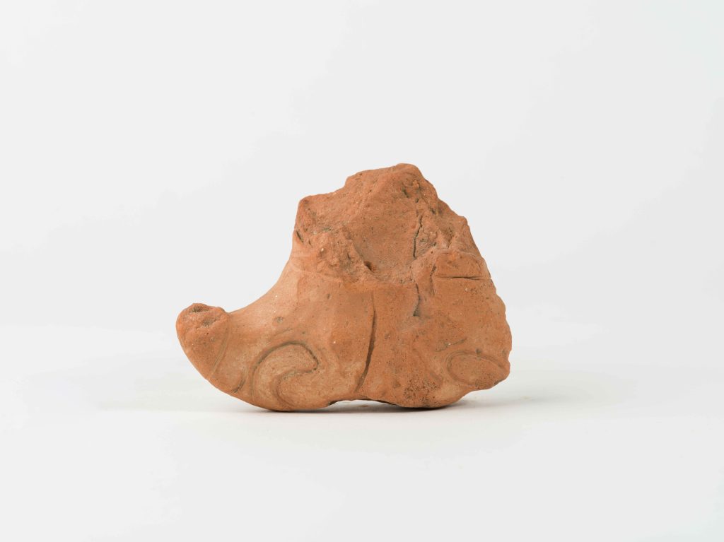 Fragment of a female terracotta figurine, preserved from the waist up