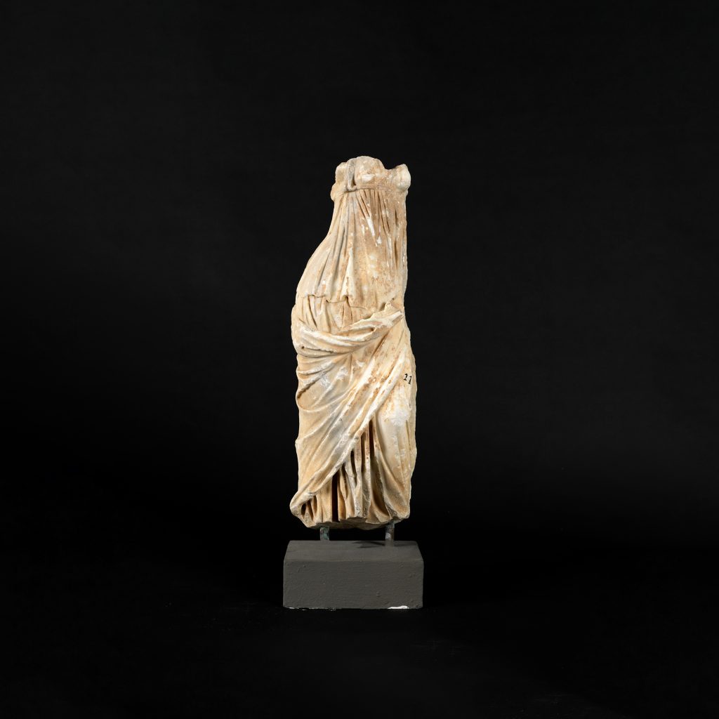 Headless female statuette