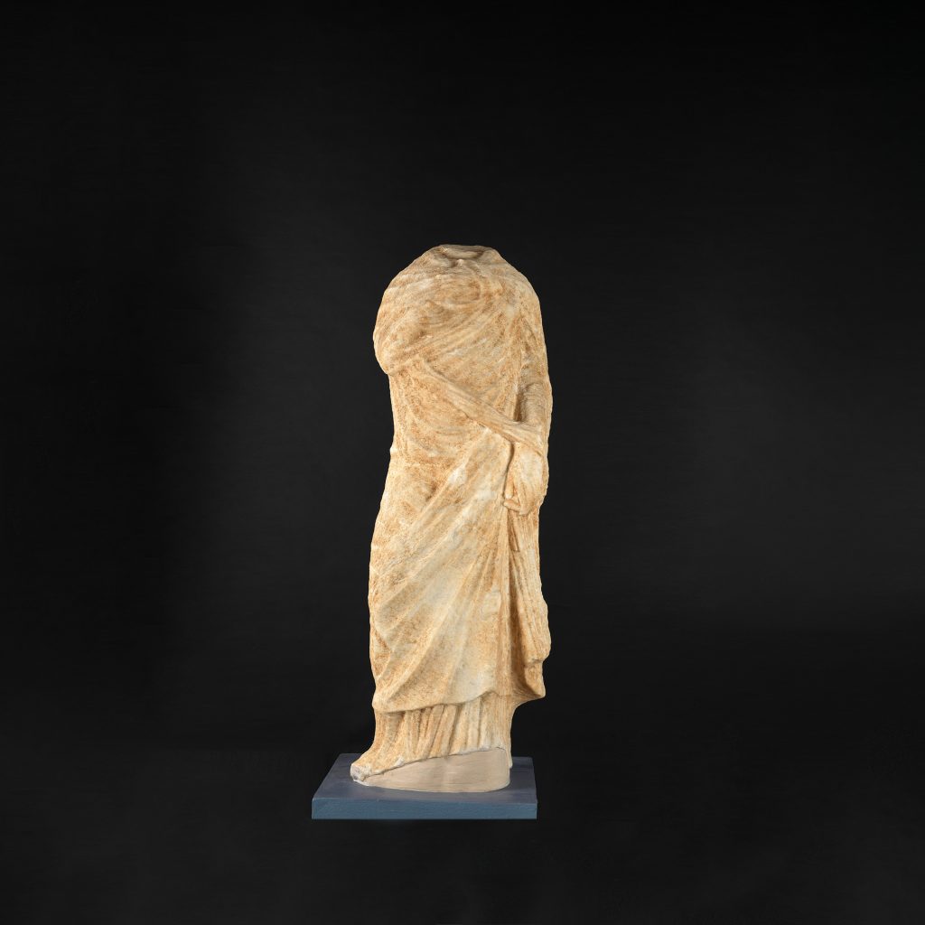 Headless statue of a standing  female figure in the type of the “Heracliotis”